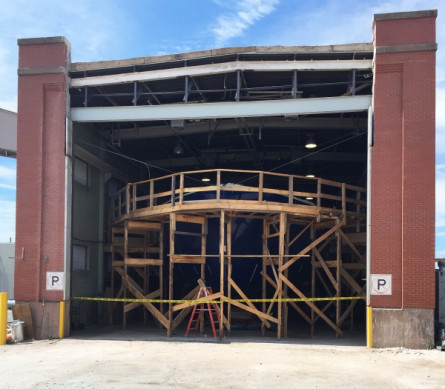 View of new door opening with scaffolding being build around hull.